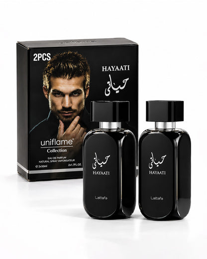 A 2-piece uniflame Collection HAYAATI perfume set, featuring two black glass bottles with silver caps and a matching black retail box with a model photo, on a white background.